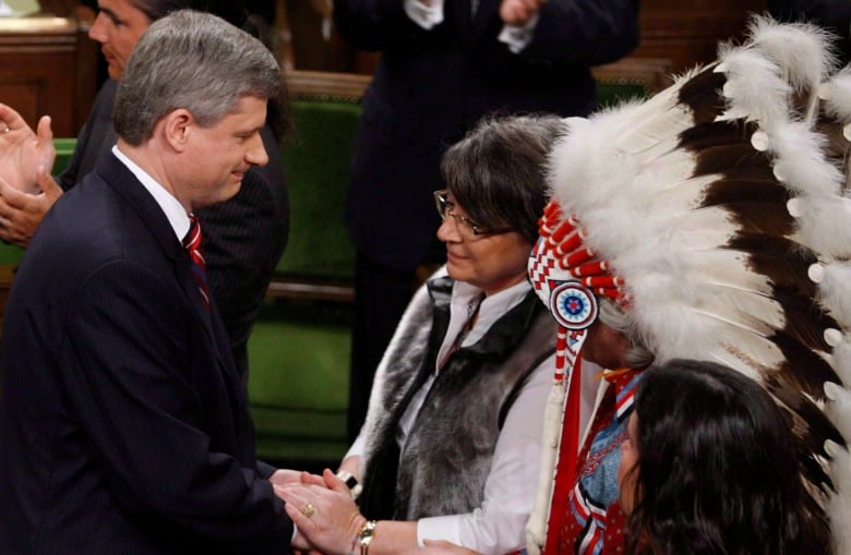 Prime Minister Stephen Harper shakes hands with Indigenous leaders on June 11, 2008 in Ottawa after apoloigizing for the residential school system.