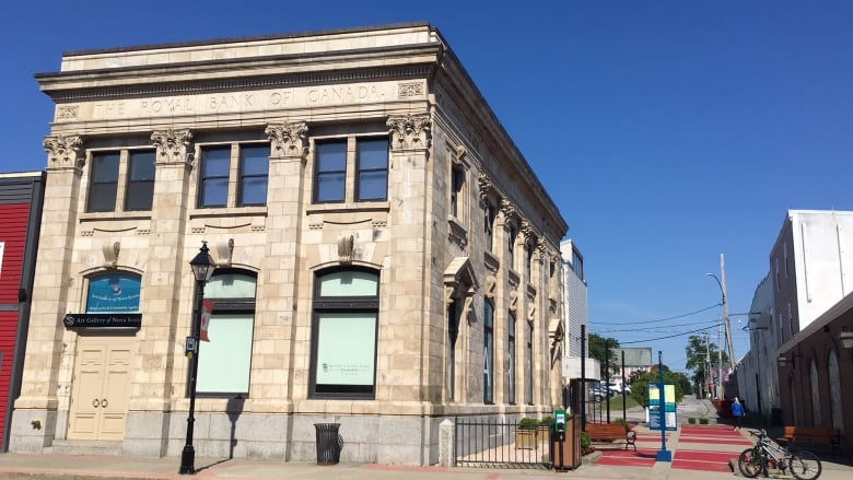 A two-story grey-beige stone building.