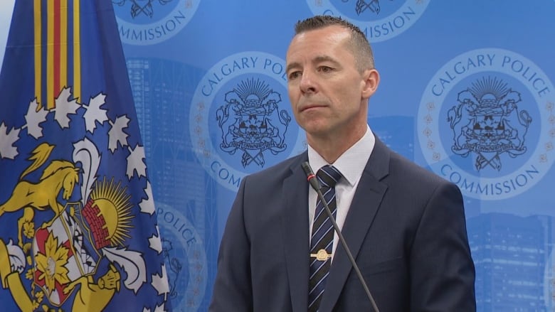 A man wearing a suit is pictured against a blue background with a logo that reads Calgary Police Commission.