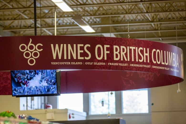 A sign over the wine aisle at a Save-On Foods grocery store says 'Wines Of British Columbia.'