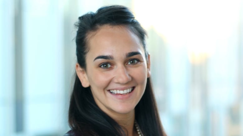 A woman smiles at the camera.