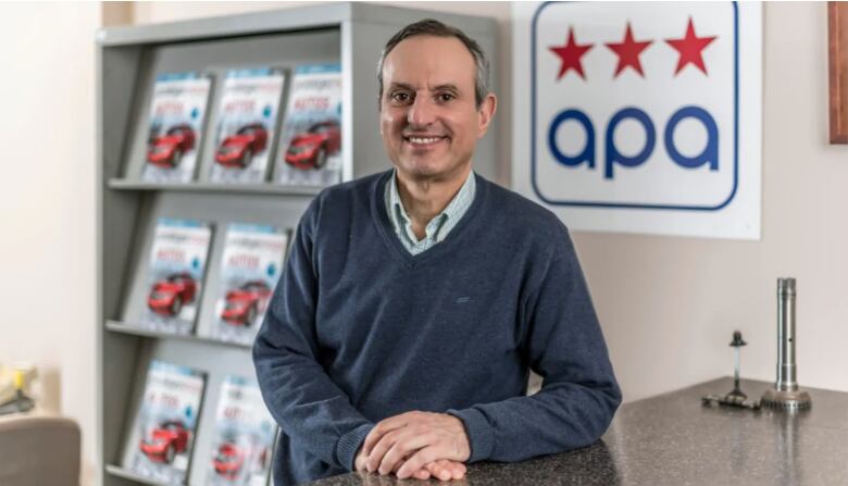 George Iny standing next to a APA sign 