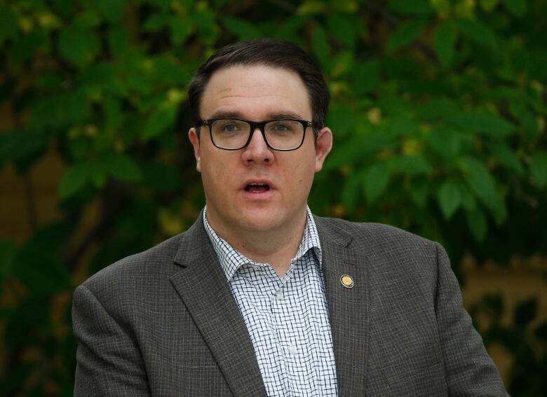 A man with glasses and dark hair. 