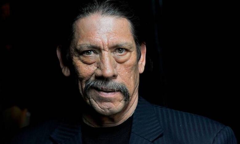 Danny Trejo looks into the camera.