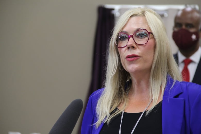 A woman with blonde hair in a blue blazer 