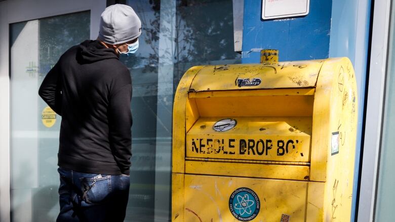 A man waits to enter a supervised consumption site.