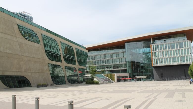 Two large horizontal buildings largely composed of glass.