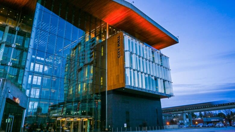 A photo of Surrey's city hall at dusk.