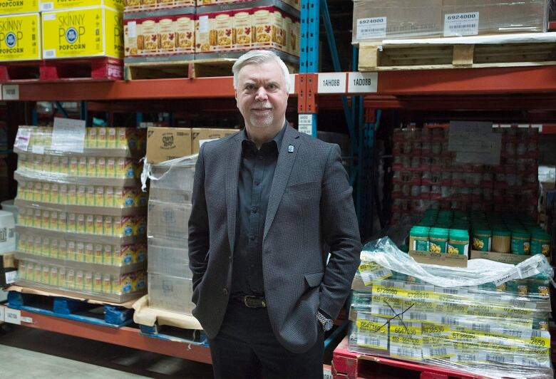 Man in front of stock of nonperishable foods