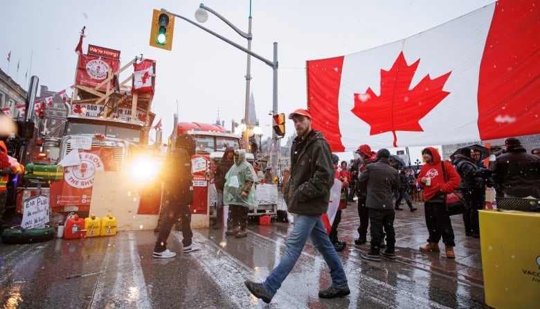 A protester walks through an encampment near Parliament Hill, in Ottawa, shortly before being arrested on Feb. 17, 2022.