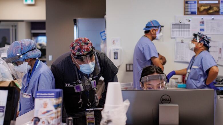 A bustling nursing station in the Humber River Hospital intensive care unit, in Toronto, is pictured on Jan. 25, 2022.