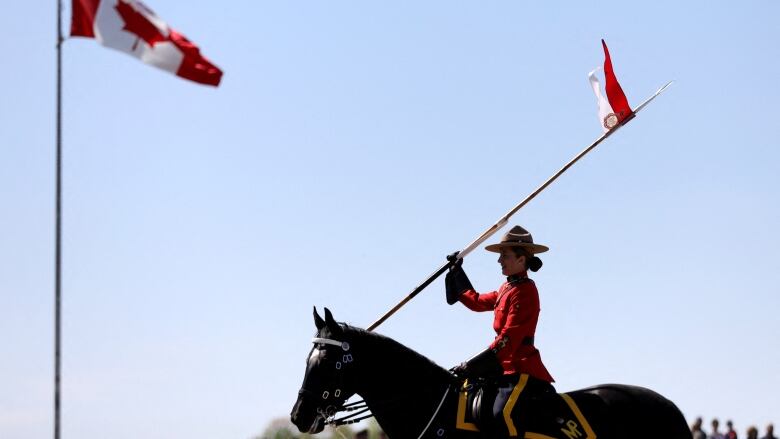 A member of Royal Canadian Mounted Police (RCMP) rides a horse, during a special performance of the Musical Ride, for the visit of Britain's Prince Charles (not pictured) and Camilla, Duchess of Cornwall (not pictured), on the second day of their Canadian 2022 Royal Tour in Ottawa, Ontario, Canada May 18, 2022.