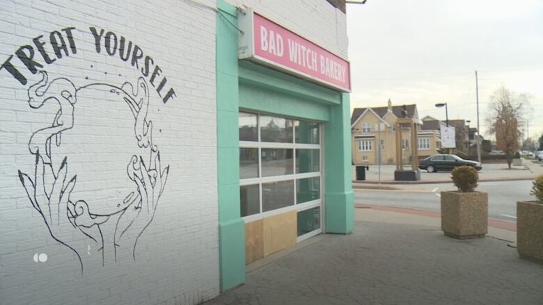 Exterior of business... two wooden boards cover windows