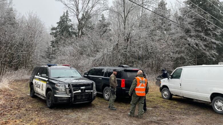 Police cars in a field.