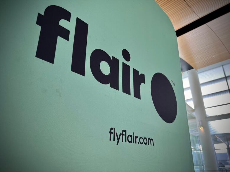 A light green sign that says 'flair' and 'flyflair.com' on it.