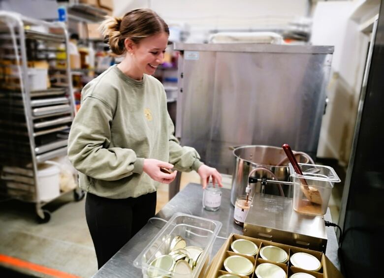 Beckie Prime mixes broths in a shared kitchen space