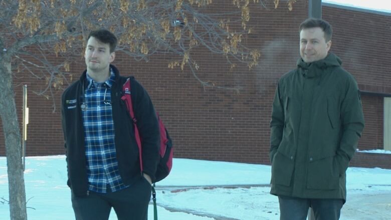 Dr. Topher Mostert, a medical resident in Lac La Biche, and Dr. Nortje walk outside the William J. Cadzow hospital.