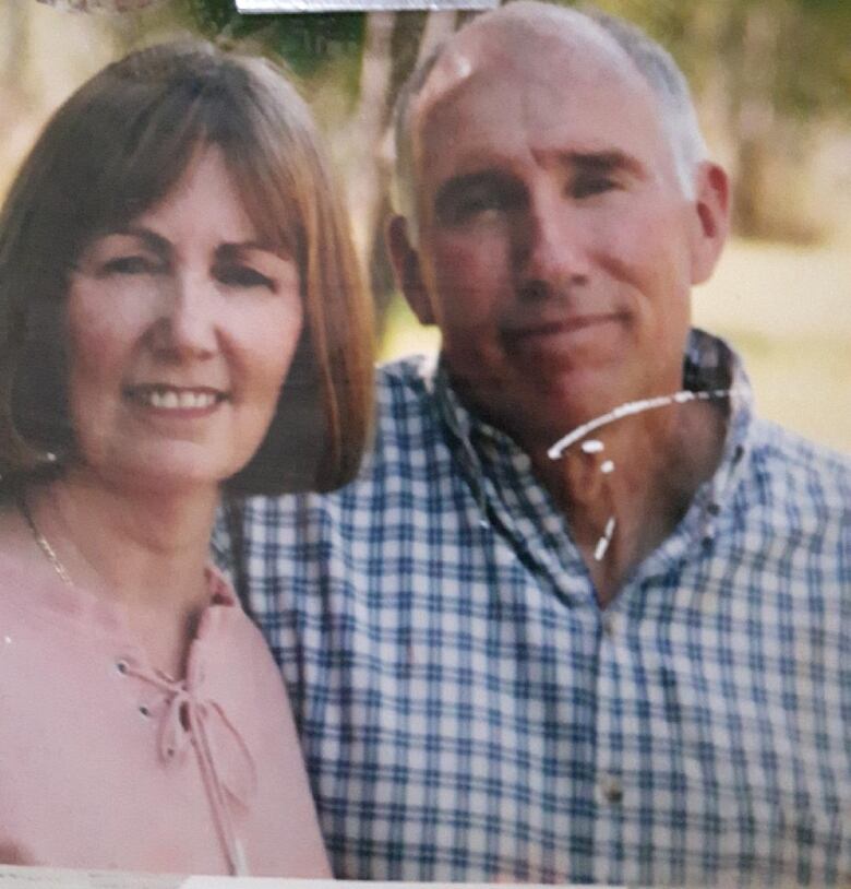 A woman and man posing for a photo.