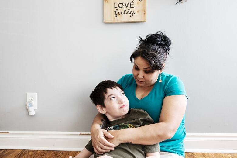 A child looks up at his mom playfully 