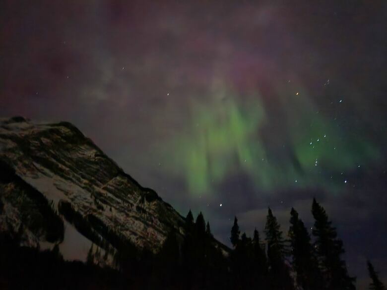 Northern lights over a mountain.