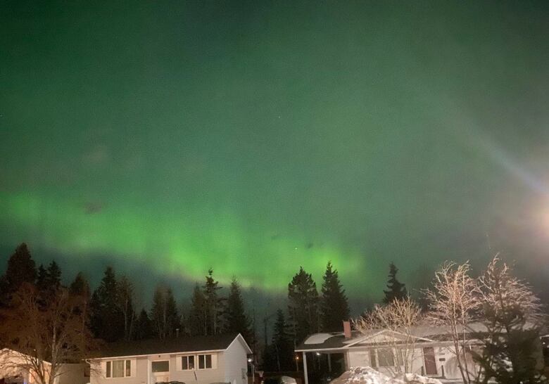 Northern lights over a city.