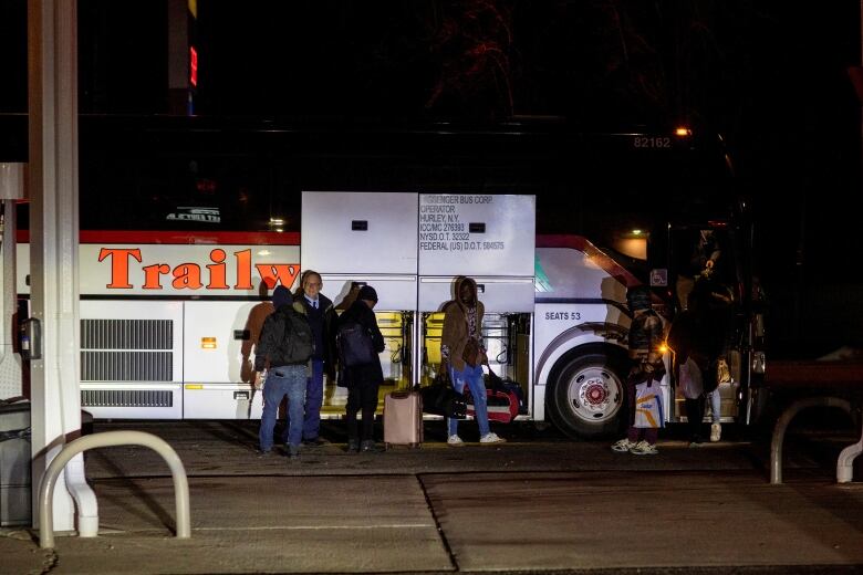 People getting off a bus.