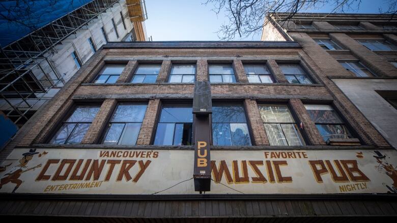 A building that serves as a rooming house also advertises Vancouver's Favourite Country Music Pub.