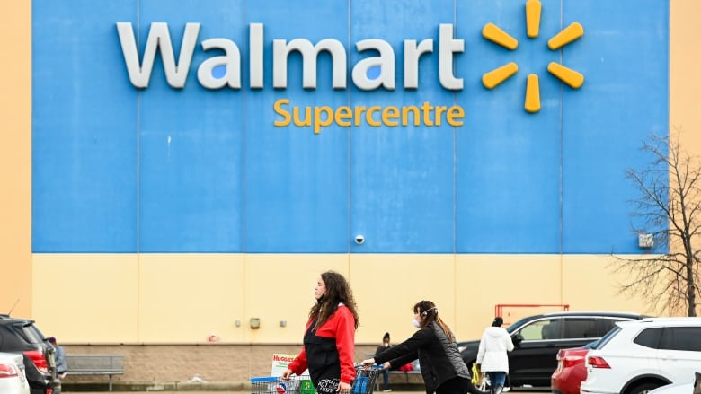 People leave the Walmart after shopping during the COVID-19 pandemic in Mississauga, Ont., Thursday, Nov. 26, 2020.