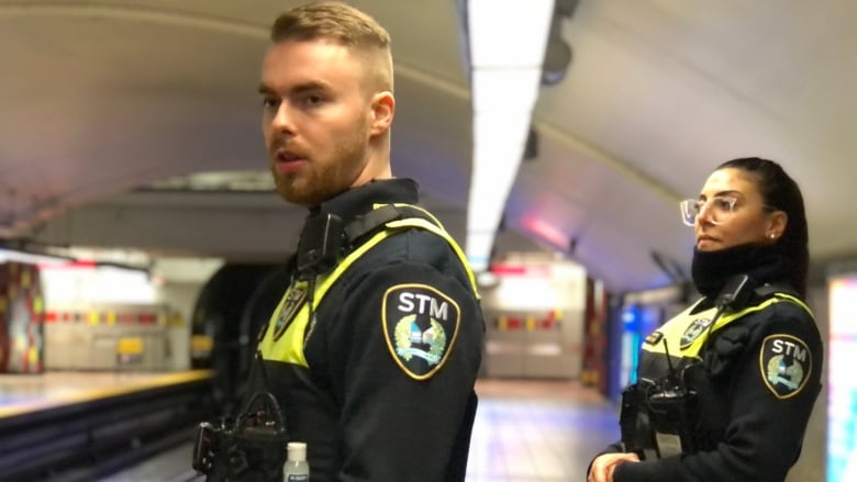 STM special constables William Barrow and Christine Cassis patrol the platform of Guy-Concordia station on the night of March 22, 2023. They wear black and neon yellow uniforms with an STM crest on the arm. It's been just over a year since STM special constables began carrying naloxone to respond to a rising number of overdoses in Montreal's metro system.