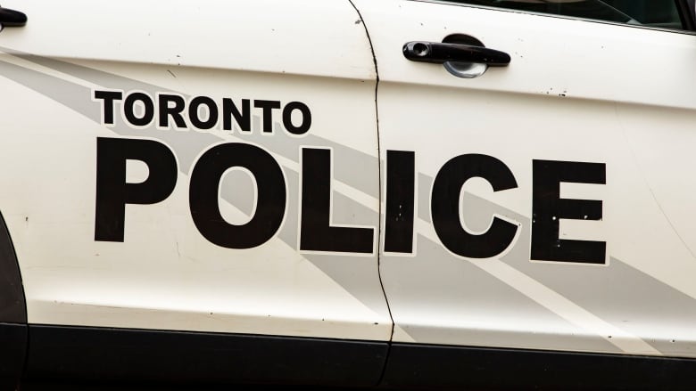 Detail view of 'Toronto Police' logo on the side of a vehicle.