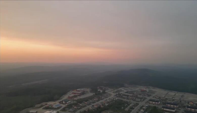 An aerial shot of Waswanipi covered by wildfire smoke.