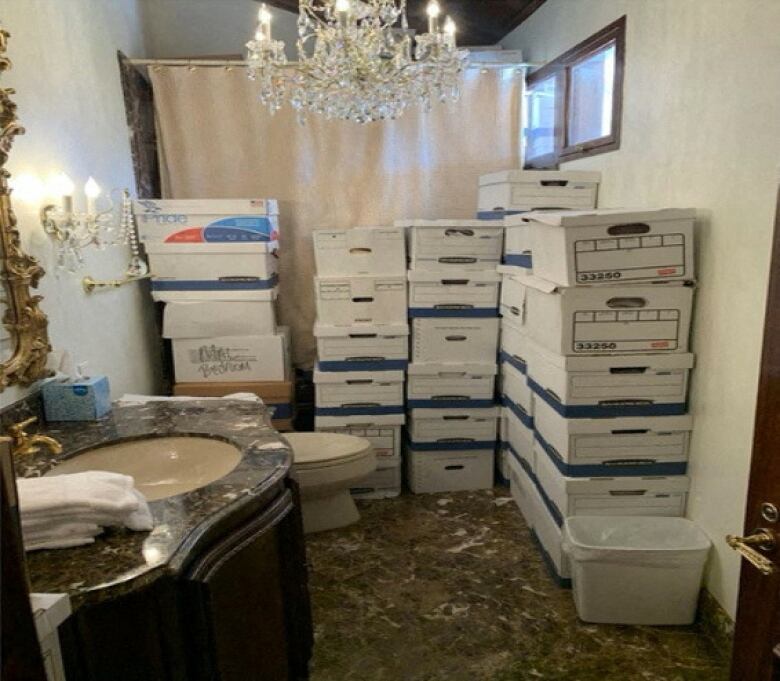 Documents are seen being stored in boxes inside a bathroom at Donald Trump's Mar-a-Lago club in Florida.