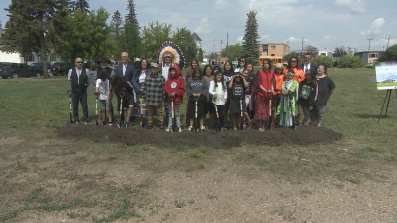 Current and Future students with shovels to celebrate the construction