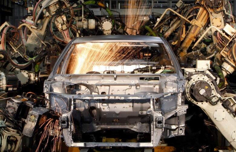 Robots weld the bodyshell of a Toyota Camry Hybrid car on the assembly line at the Toyota plant in Melbourne August 31, 2009. The pilot production of the first Australian-built hybrid car has been officially launched in Melbourne today. The government has backed the project with $35 million Australian dollars ($29.4 million) to support Toyota's plans to make 10,000 Camry hybrids each year from 2010 at the Altona assembly plant from 2010. REUTERS/Mick Tsikas (AUSTRALIA TRANSPORT ENVIRONMENT BUSINESS)