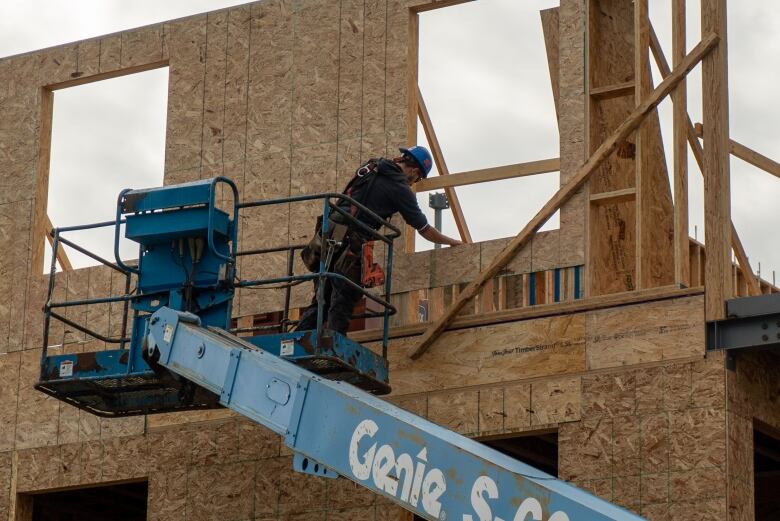 A construction worker builds a home. 