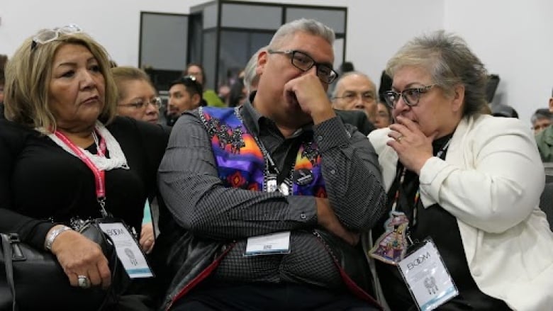 A man with his hand on his chin, thinking.