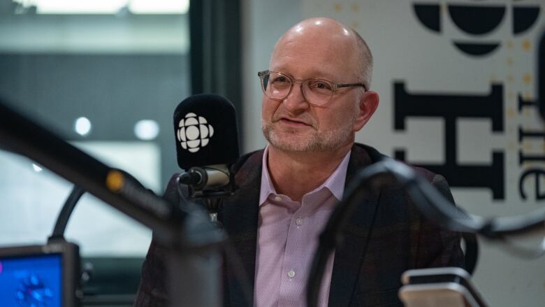 A man speaks into a microphone.