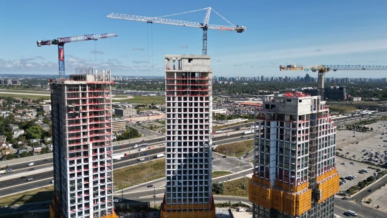 Aerial view of three high-rise residential towers under construction on Dufferin Street in North York. 