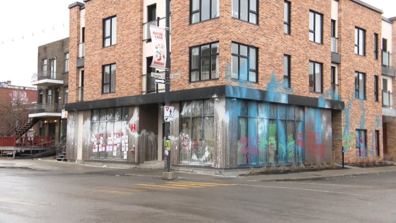 A building is spray painted and full of graffiti.