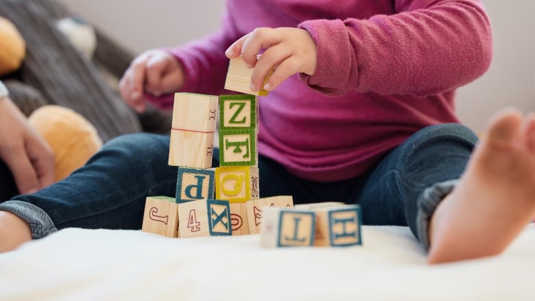 A baby plays with blocks.