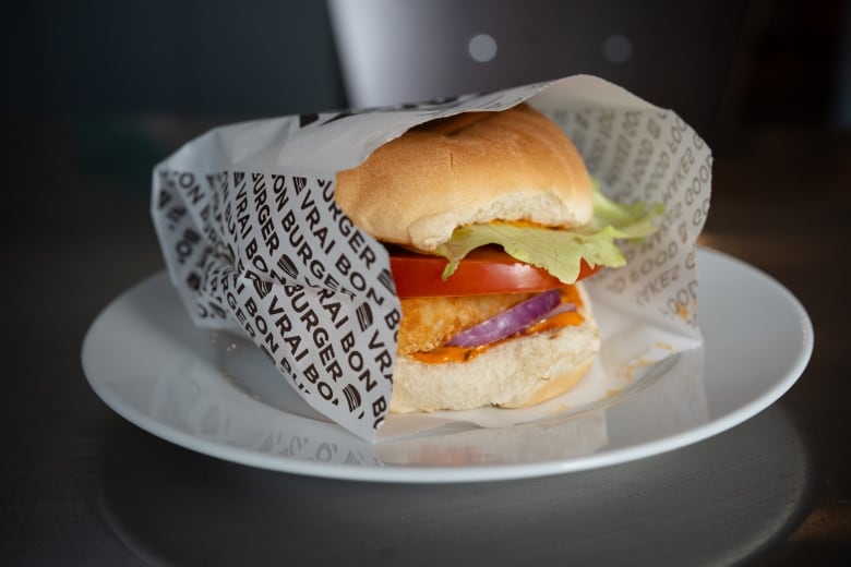 A close-up of an A&W burger with a hashbrown instead of a beef patty.