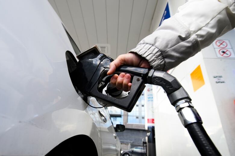 A woman gasses up at a gas station in Mississauga, Ont.,  Tuesday, February 13, 2024. Ontario Premier Doug Ford says his government will introduce legislation that would put any future provincial carbon pricing program to a referendum. THE CANADIAN PRESS/Christopher Katsarov