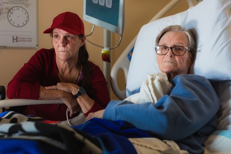 Michele Campeau, left, visits with her mother, Ruth Poupard, 83, at Hotel-Dieu Grace Healthcare where she is recovering from a broken hip, in Windsor, Ont., on Wednesday, April 3, 2024. Poupard also suffers from dementia and requires 24-hour care. 