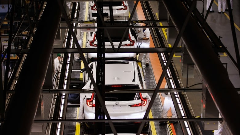 White Honda CRVs are seen in a row along the production line at Honda Canada's facility in Alliston, Ont.