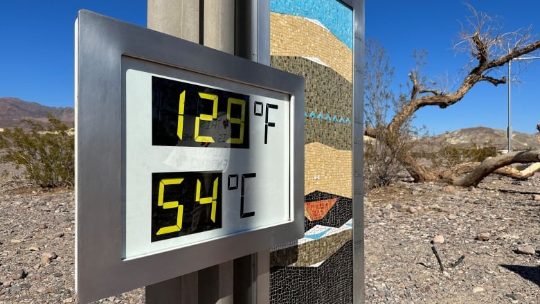 A digital sign shows a temperature of 54 degrees Celsius and 129 degrees Fahrenheit. 