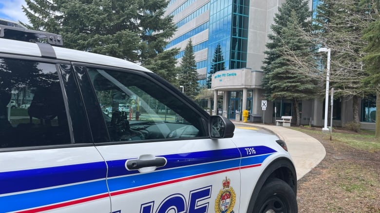 Police vehicle parked at a sidewalk.