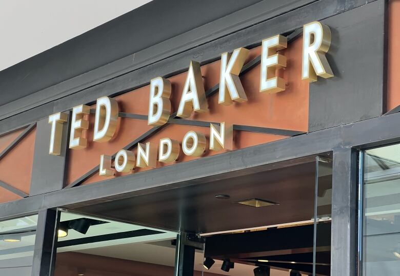 A sign over a door says TED BAKER LONDON in all caps.