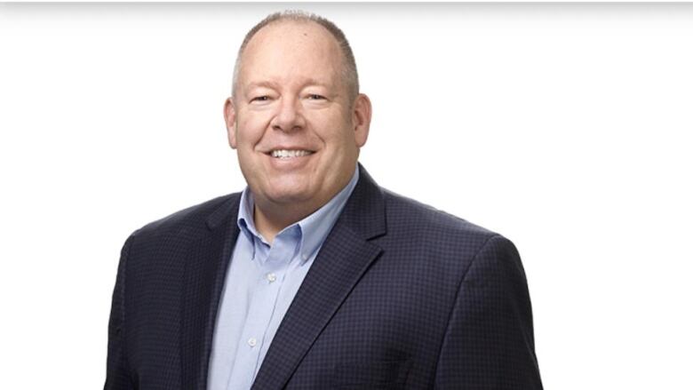 A smiling man in a suit.