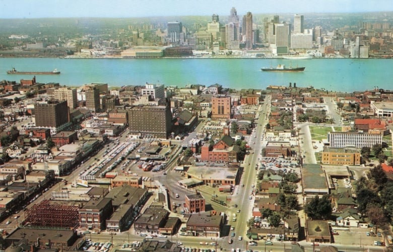 A photo shows buildings of Windsor from the sky, the Detroit River and some of Detroit.