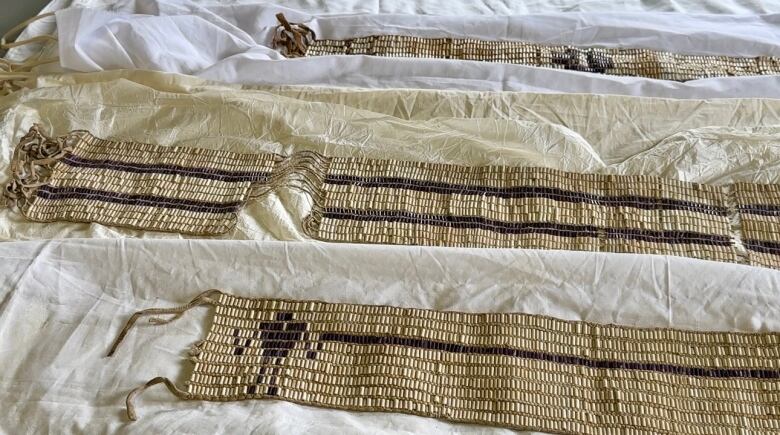 Old wampum belts. Beading has yellowed and some are missing.